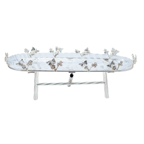 PRESENTOIR OVAL PLATEAU VERRE TRANSPARENT SUPPORT ARGENTE METAL FORGE PIEDS CROISE PAPILLON FLEUR - L'Atelier de Dadi - vaisselle de luxe - Dakar - Senegal